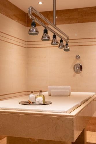 a sink with three lights on top of it at Vila Gale Albacora in Tavira