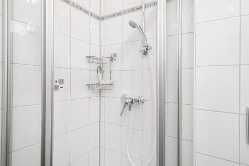 a bathroom with a shower with a shower head at Haus Baden in Hagnau