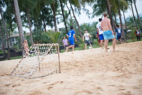 a group of people playing soccer on a beach at The Haven Khao Lak in Khao Lak