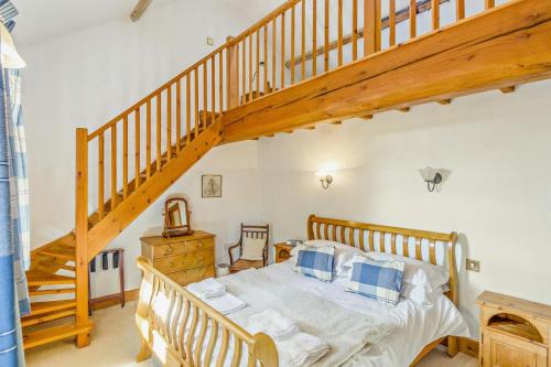 a bedroom with a wooden bed and a staircase at 1 Bed in Market Rasen oc-73852 in East Barkwith