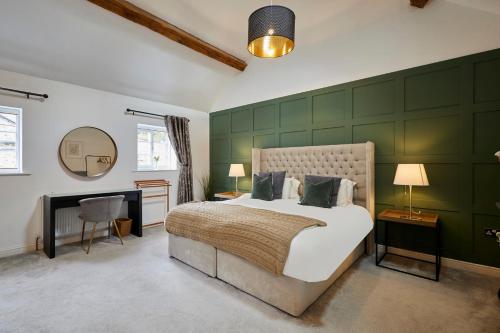 a bedroom with a large bed with a green wall at Host & Stay - Greengate Cottage in York