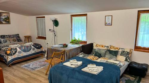a living room with a bed and a couch at Nyárfa Vendégház in Debrecen