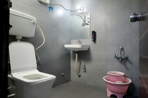 a small bathroom with a toilet and a sink at HOTEL GOLD LEAF in Ahmedabad