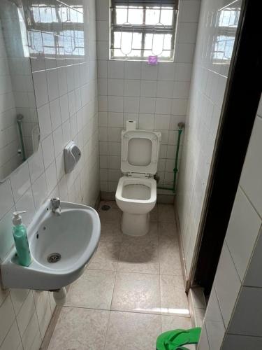 a bathroom with a toilet and a sink at TULIVU Homes in Mombasa