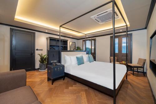 a bedroom with a large bed and a couch at Merchant's Gate Songwat in Bangkok
