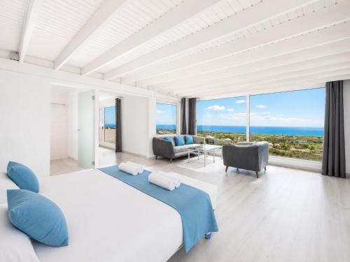 a bedroom with a large bed and a view of the ocean at The View in Tías