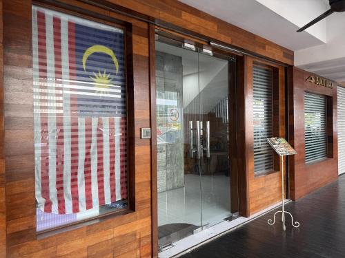 a store front with an american flag in a window at Palette - Bukit Mata Boutique Hotel in Kuching