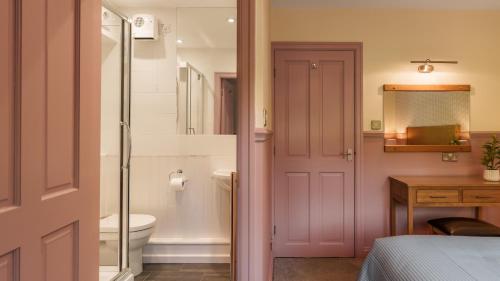 a bathroom with a shower and a toilet and a sink at Dog Friendly Lakeland Cottage At Windermere Marina Village in Bowness-on-Windermere