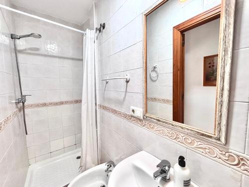 a bathroom with a sink and a mirror at Easy Nerja Apartments in Nerja