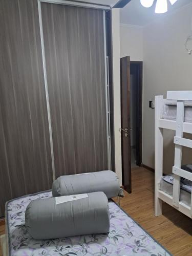 a room with two beds and a closet with a door at Departamento juana con cochera in Rafaela