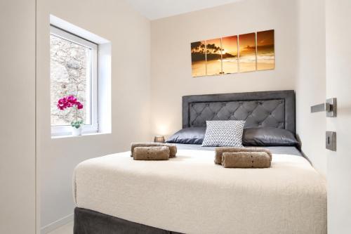 a bedroom with a large bed with two stools on it at Casa del Sole - Ugljan Island in Poljana