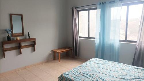 a bedroom with a bed and a mirror and a window at Gira Lua in Igreja