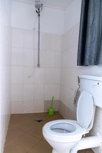 a bathroom with a toilet and a shower at La casa Cottage in Iringa