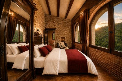 a bedroom with two beds in a room with windows at Fortaleza Medieval La Manyosa in Granera