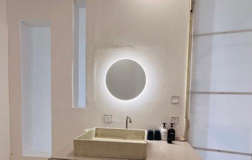 a bathroom with a sink and a mirror on the wall at Siquijor Jade ocean resort in Siquijor