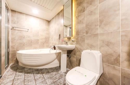 a bathroom with a toilet and a sink and a tub at 로미오앤줄리엣 in Daegu