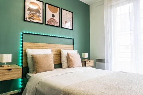 a bedroom with a large bed with green walls at Évasion étoilée in Corbeil-Essonnes