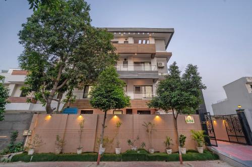 a building with trees in front of a fence at Treebo Modern Stays in Noida