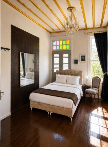 a bedroom with a large bed and a mirror at No16 Ada in Adalar