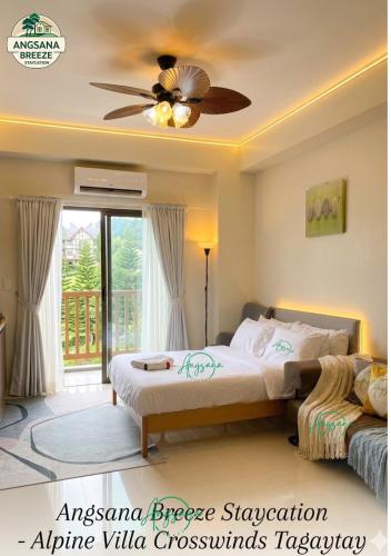 a bedroom with a bed and a ceiling fan at Angsana Breeze-Alpine Crosswinds Tagaytay in Ulot