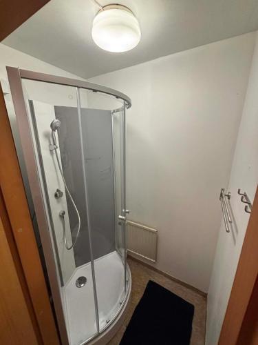 a bathroom with a shower with a toilet and a light at Vannebodagatan in Frövi