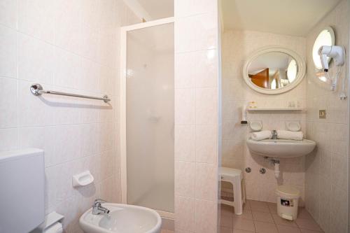 a bathroom with a shower and a sink and a toilet at Hotel Sorriso in Brenzone sul Garda