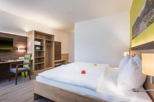 a hotel room with a bed with a desk and a computer at Sleepin Premium Motel Loosdorf in Loosdorf