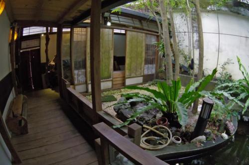 a house with a garden with plants and scissors at A-HOME in Jiufen
