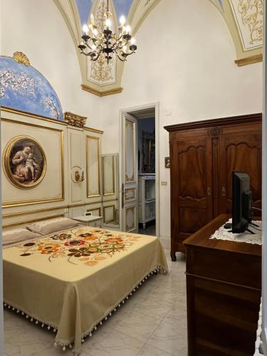 a bedroom with a bed and a television in it at Casa del Conte in Parabita
