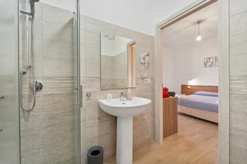 a bathroom with a sink and a shower at CLASS ROOMS AFFITTACAMERE con bagno privato , vicino alle DUNE di PORTO PINO in SantʼAnna Arresi