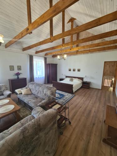 a large living room with a couch and a bed at Vila Varėna in Varėna