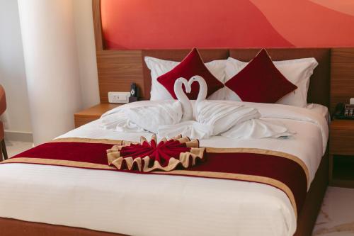 a bed with a swan decoration on top of it at GermanHomesHotel in Thimi