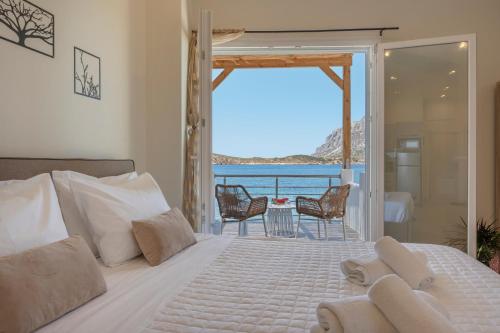 a bedroom with a bed and a view of the ocean at Next to the wave in Myrties