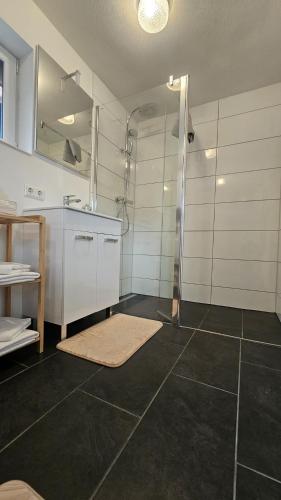a bathroom with a shower and a sink at Schwarzwald Lodge Schonach in Schonach