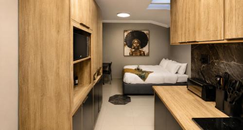 a bedroom with a bed and a television in a room at Bryanston Palms Accommodation in Johannesburg