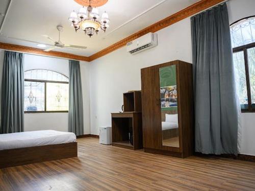 a bedroom with a bed and a mirror in it at Saal house in Nizwa