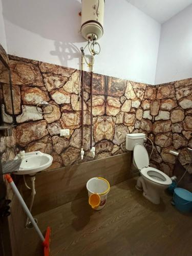 a bathroom with a toilet and a sink at Utsav riverbank homestay in Haldwāni