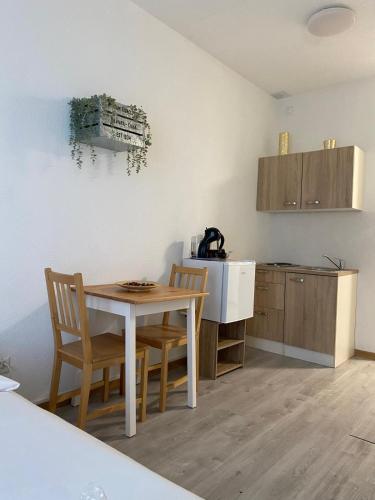 a kitchen with a table and two chairs and a counter at Fortezza in Bellinzona