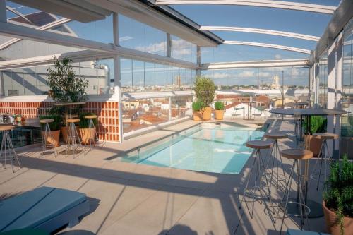 a balcony with a swimming pool on a building at Room Mate Oscar, Madrid in Madrid