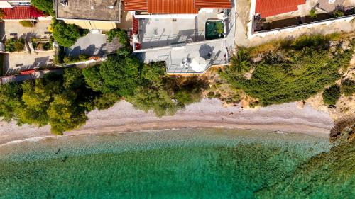 an aerial view of the beach and the ocean at Deep Blue Escape Villa Salamina in Áyios Yeóryios