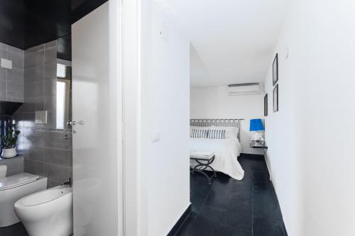 a white bathroom with a bed and a sink at Villa Margi in Vico Equense