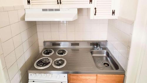 a small kitchen with a sink and a stove at Magnuson Hotel Sierra Vista in Sierra Vista