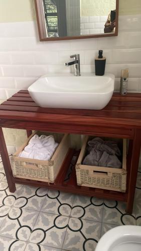 a bathroom with a sink and a counter with baskets at Indaba tree lodge in Bulawayo