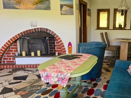a table and chairs in a living room with a fireplace at Reethus Mandy in Staphel