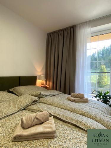 two beds sitting next to each other in a bedroom at Apartmán KOZAK LITMAN in Litmanová