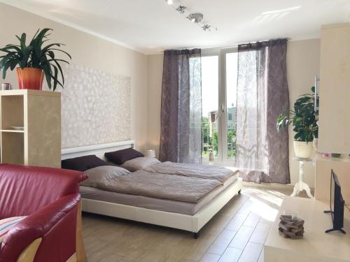 a bedroom with a bed and a large window at Ferienwohnung *Richi* in Sassnitz