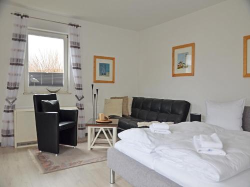 a living room with a bed and a couch at Villa Monika App 7 in Sassnitz