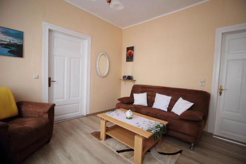 a living room with a couch and a coffee table at Ferienwohnung Thurk in Sassnitz