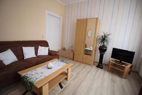 a living room with a couch and a coffee table at Ferienwohnung Thurk in Sassnitz
