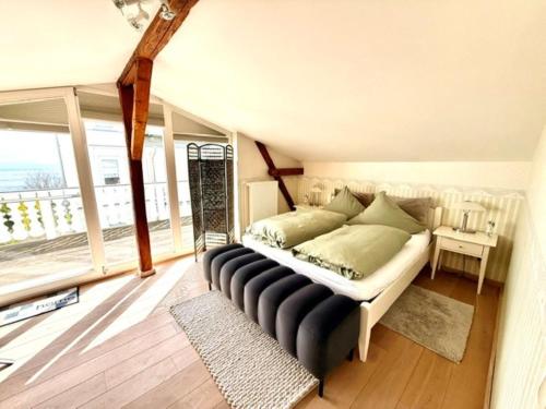 a bedroom with a large bed with a large window at Villa Seestern - Ferienhaus mit Meerblick in Sassnitz